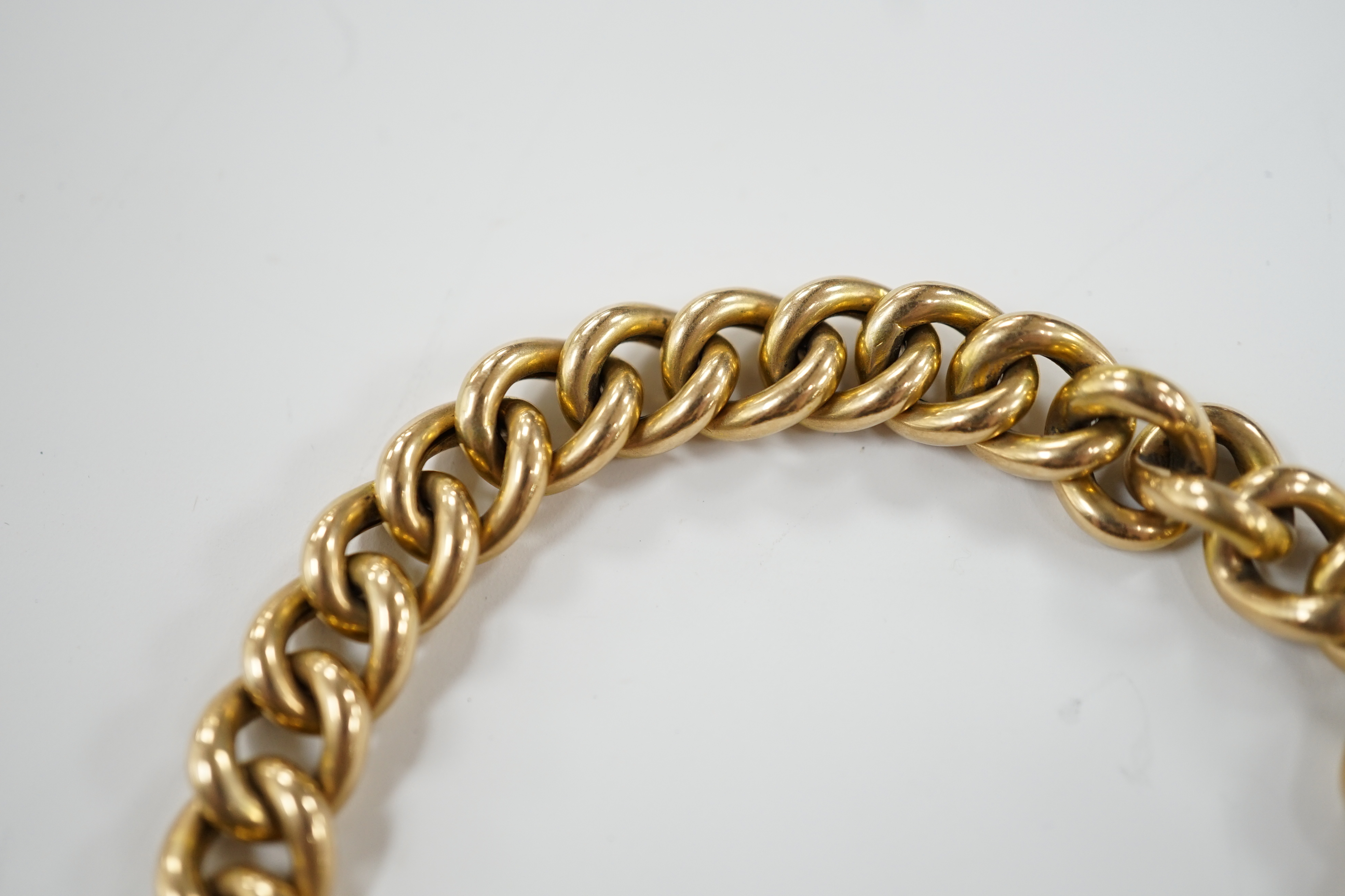 An Edwardian 15ct gold curb link bracelet, with heart shaped padlock clasp, 20cm